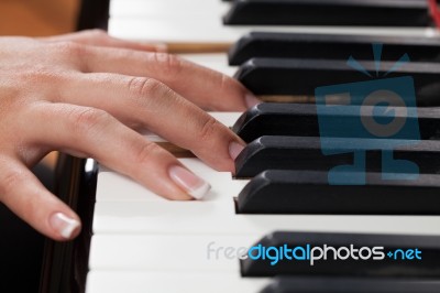 A Woman Playing Piano Stock Photo