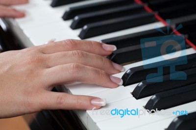 A Woman Playing Piano Stock Photo