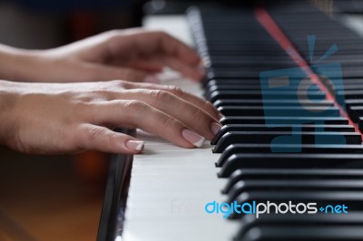 A Woman Playing Piano Stock Photo