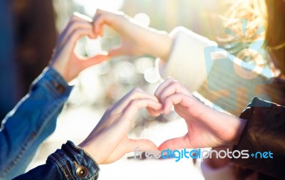 A Young Woman's Hands Making A Heart Shape Stock Photo