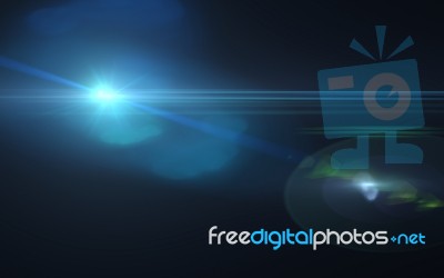 Abstract Blue Lens Flare And Black Background Stock Image