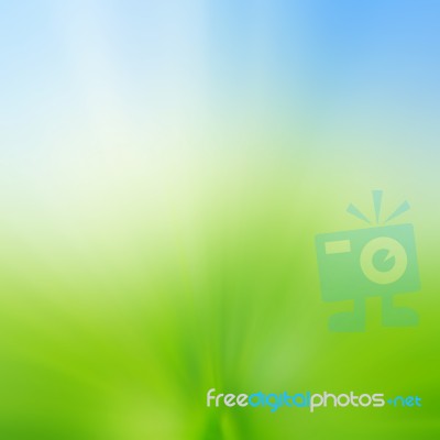 Abstract Blur Background Of Green Grass Field And Blue Sky Above… Stock Photo