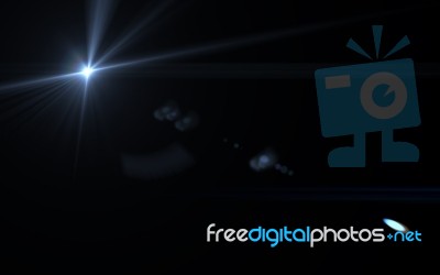 Abstract Digital Sun Light And Lens Flare In Black Background Stock Image