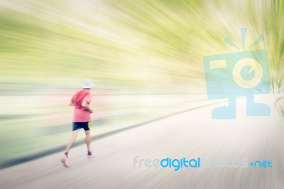 Abstract Image Of Man Jogging  In The Park,. Motion Blur Effect Stock Photo