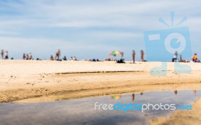 Abstract Of Blurred People On The Beach Stock Photo