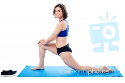 Active Female Tightening Up Her Thigh Muscles Stock Photo