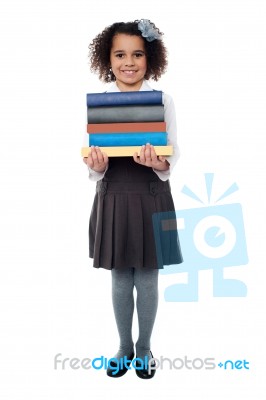 Active School Child Carrying Stack Of Books Stock Photo