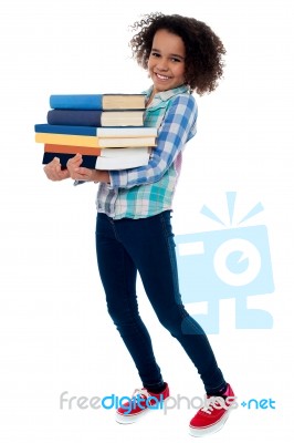 Active Young School Kid Carrying Books Stock Photo