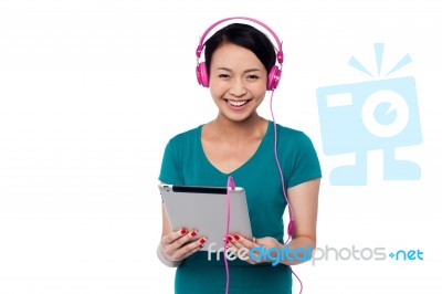 Adorable Girl Watching Video On Tablet Device Stock Photo