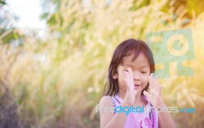 Adorable Little Girl Laughing In A Meadow - Happy Girl At Sunset… Stock Photo