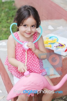 Adorable Little Girl Playing Doctor With Stethoscope Out Door Stock Photo