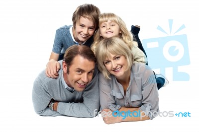 Adorable Young Kids Piled On Top Of Their Parents Stock Photo