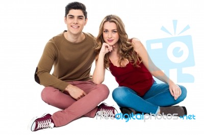 Adorable Young Lovers Sitting On The Floor Stock Photo