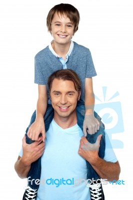 Adorable Young Son Enjoying Piggyback Ride Stock Photo