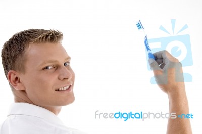 Adult Caucasian Holding Toothbrush And Posing To Camera Stock Photo