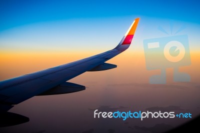 Aerial View Of Airplane Fly During The Sunset From Windows Plane… Stock Photo