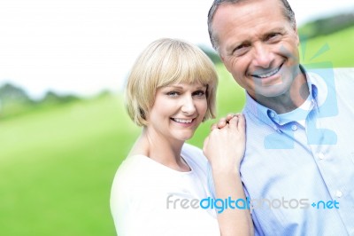 Affectionate Couple Smiling At Camera Stock Photo