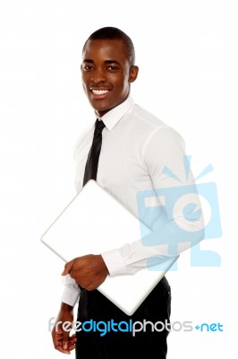 African Businessman Carrying Laptop Stock Photo