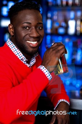 African Guy Drinking Chilled Beer Stock Photo