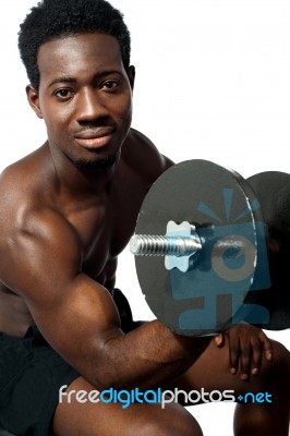 African Guy Lifting Dumbbells Stock Photo