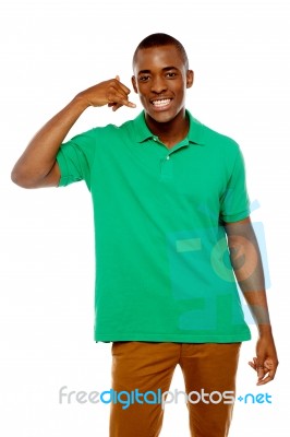 African Guy Showing Call Me Gesture Stock Photo