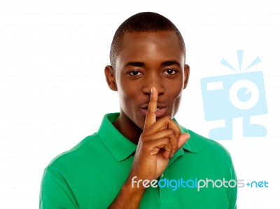 African Guy Showing Silence Gesture Stock Photo