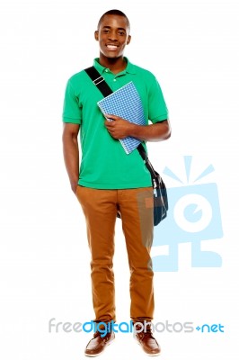 African Male Holding Book And Bag Stock Photo