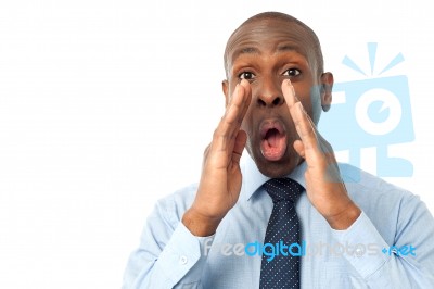 African Man With Hands To Mouth Yelling Stock Photo