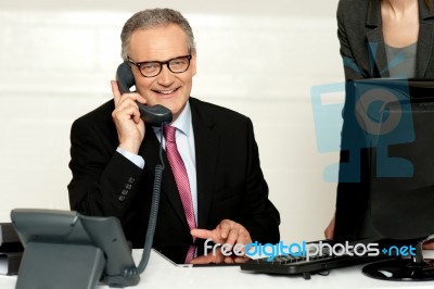 Aged Businessman Communicating On Phone Stock Photo