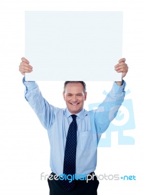 aged Businessman holding empty sign Stock Photo