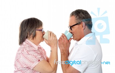 Aged Couple Drinking Coffee Stock Photo