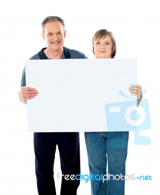 Aged Couple Holding Blank Board Stock Photo