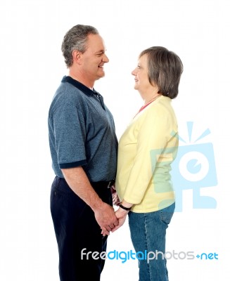 Aged Couple Holding Hands With Love Stock Photo