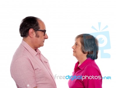 Aged Couple Looking Each Other Stock Photo