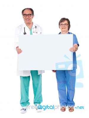 Aged Doctors Holding Blank Board Stock Photo