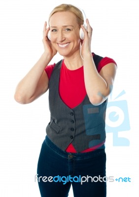 Aged Female Enjoying Music Stock Photo