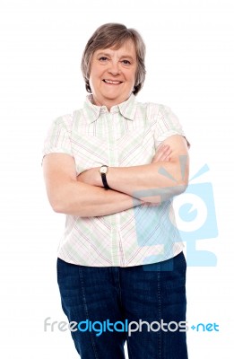 Aged lady standing with arm crossed Stock Photo