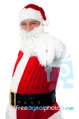 Aged Man In Santa Costume Offering Keys Stock Photo