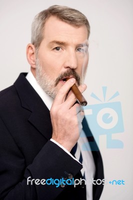 Aged Man Smoking Cigar Over White Stock Photo