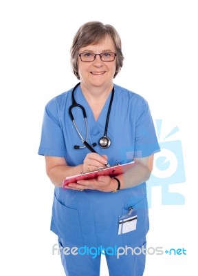 Aged Surgeon Writing Prescription Stock Photo