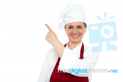 Aged Woman Chef Pointing Up Stock Photo