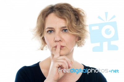 Aged Woman Gesturing Silence Stock Photo