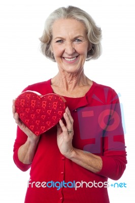 Aged Woman Holding A Red Valentine Gift Box Stock Photo