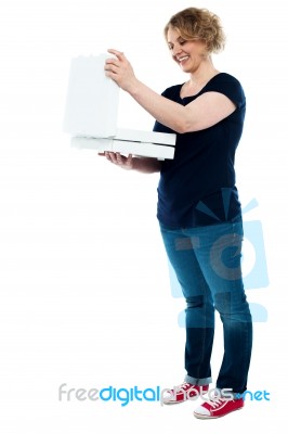 Aged Woman Looking Pizza Box Stock Photo