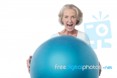 Aged Woman Posing With Exercise Ball Stock Photo