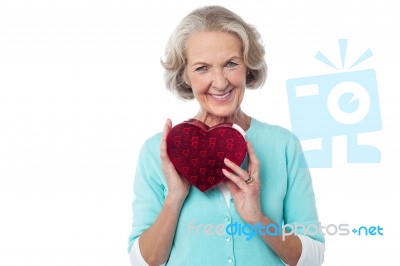 Aged Woman Symbolizing Love, Holding Gift Stock Photo