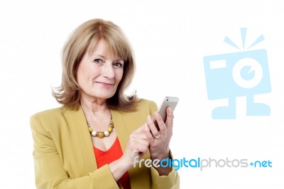 Aged Woman Using Smart Phone Stock Photo