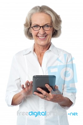 Aged Woman Using Touch Pad Device Stock Photo