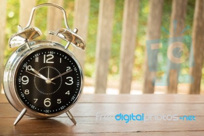 Alarm Clock On Wooden Background Stock Photo