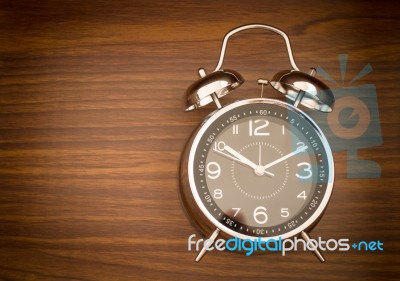 Alarm Clock On Wooden Background Stock Photo